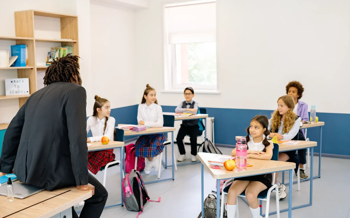 A teacher guiding learners in a structured classroom lesson