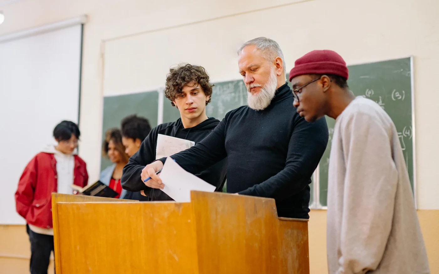 An educator and students discussing a learning activity together