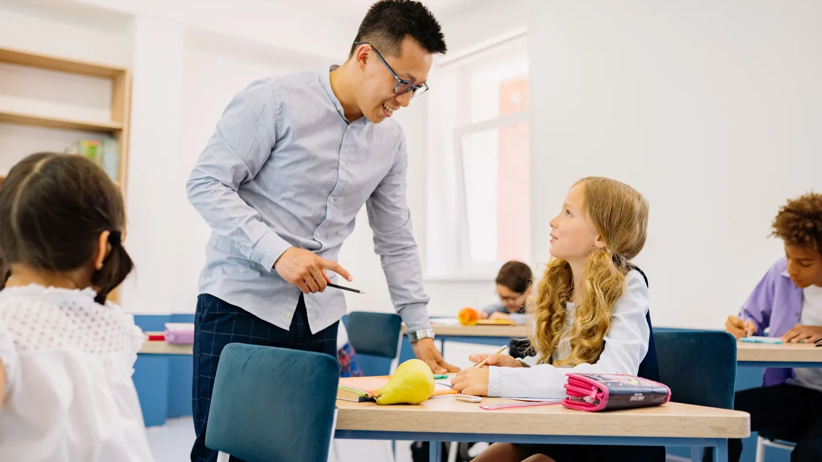 A teacher supporting learners during a classroom assessment activity